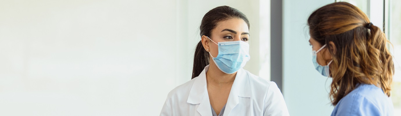 Two female health care workers wearing masks
