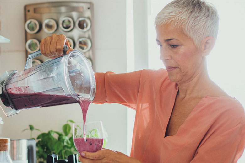Woman pouring smoothie